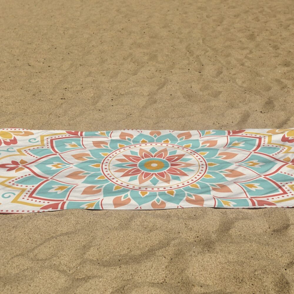 white beach towel psd mockup laying on the sand